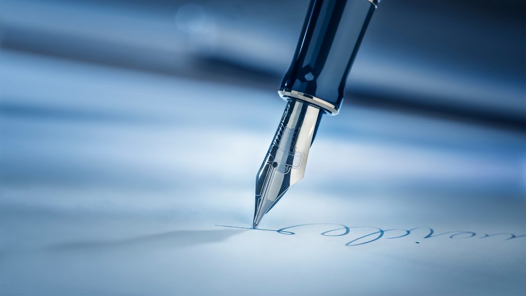 Signing a legal document with a fountain pen