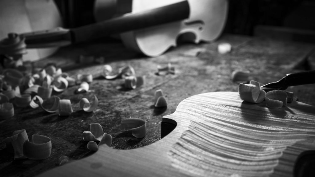 Detail of the violin woodcarving process, it is all about craftsman's experience, Italy