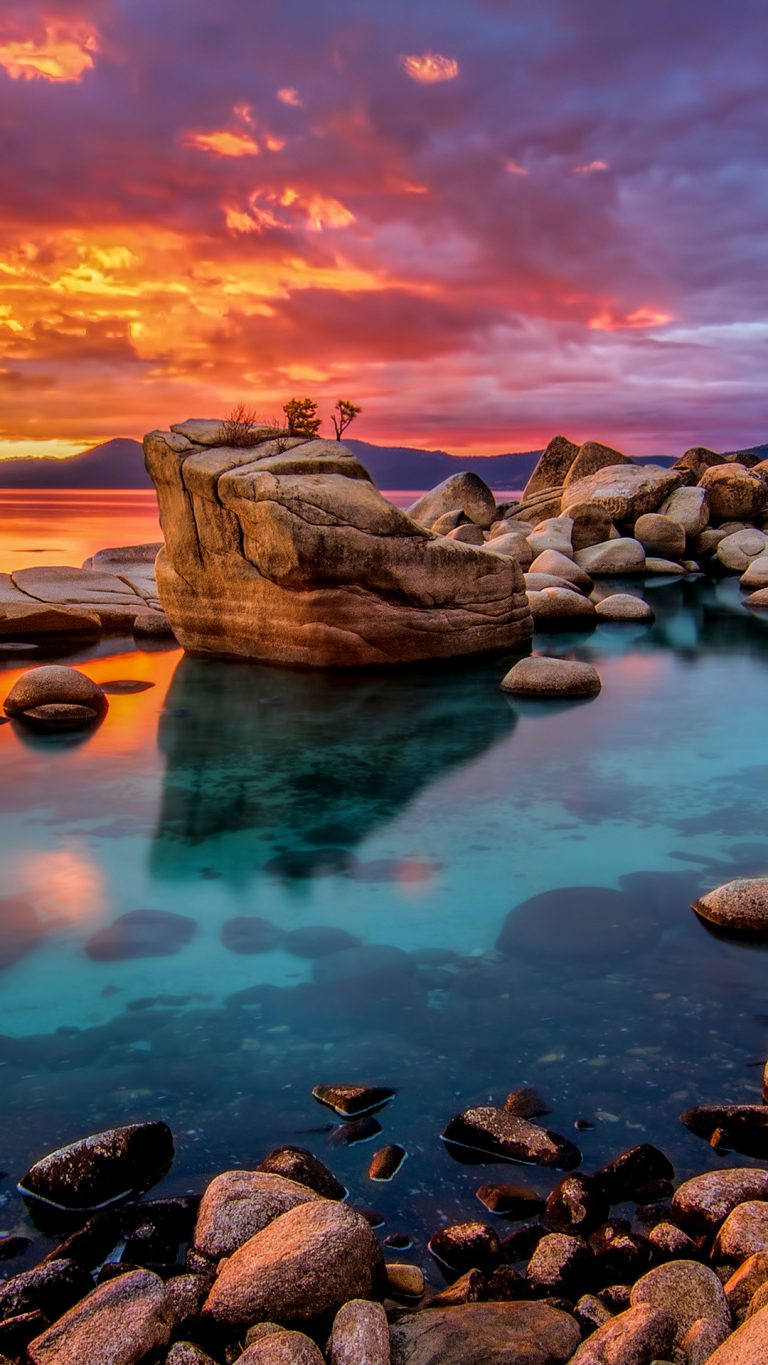 Candy colored skies sunset at shoreline of Lake Tahoe, Nevada, USA