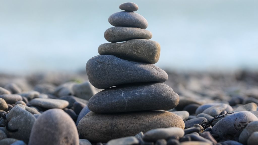 Pyramid of pebble stones, stone stack on pebble beach