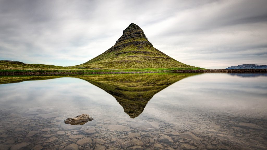 Kirkjufell mountain reflecting in calm waters, Snæfellsnes peninsula, Iceland
