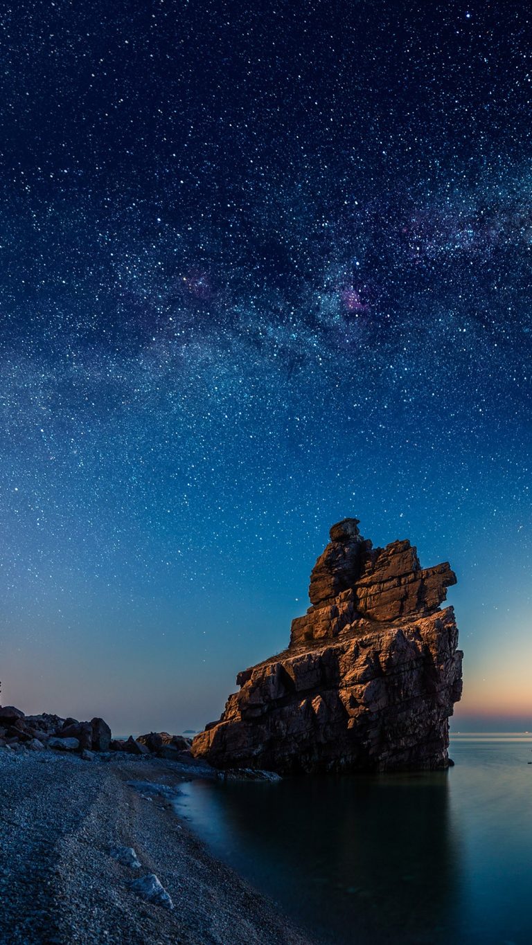 Starry night over rock formations by the Pacific Ocean, Dalian ...