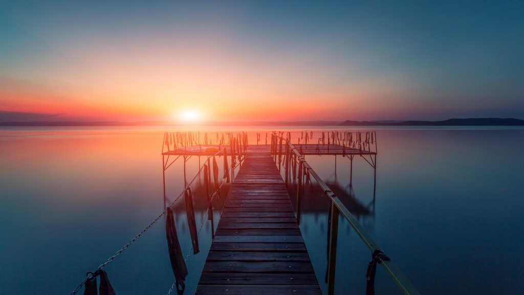 Sunset over water, pier at Balaton lake, Hungary