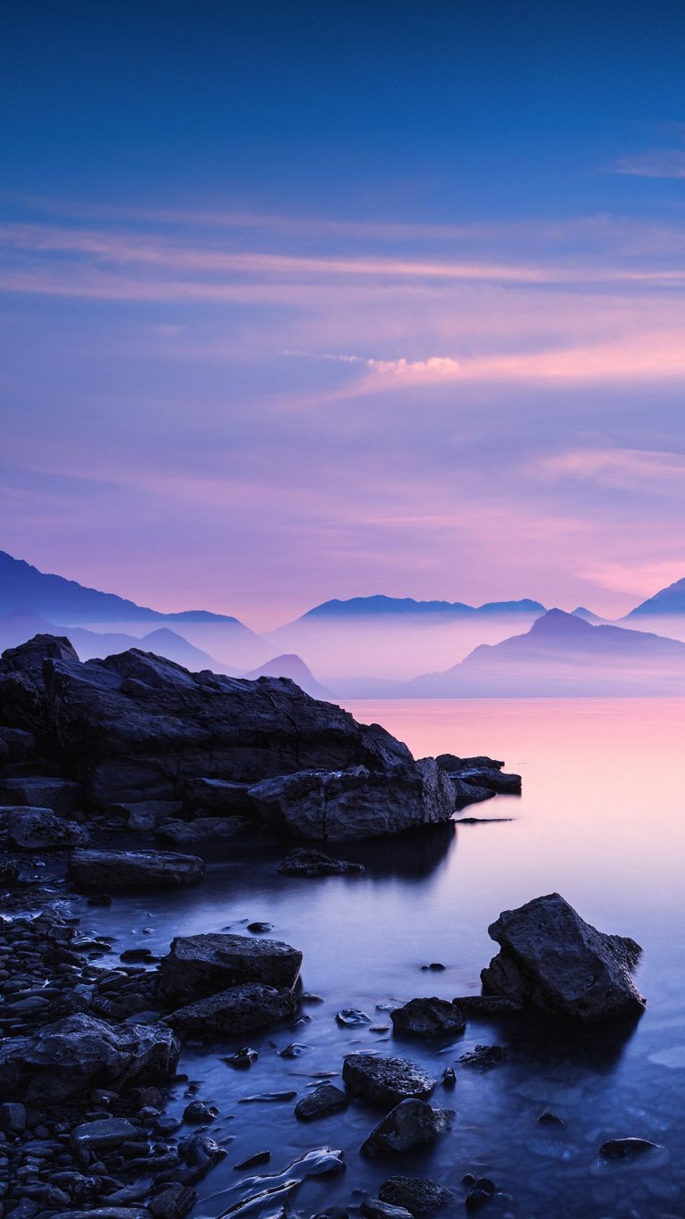 Sunset on a sea rocky beach, pink mountains | Windows Spotlight Images