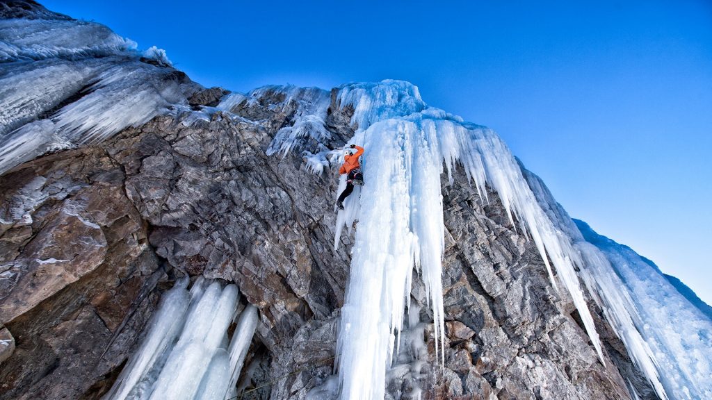 Man climbing frozen waterfall, Lake City, Colorado, USA