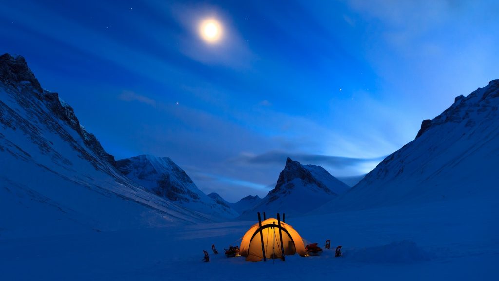 Tent under the night sky in snow covered Lapland near Nallo, Sweden