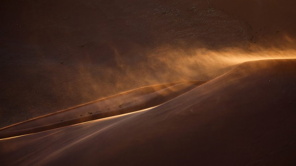 Sand blowing off the top of a dune in Sossusvlei, Namib-Naukluft National Park, Namibia