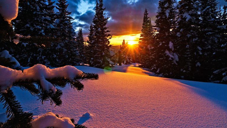 Fresh snow and pink alpenglow light at sunset in mountains. Colorado ...