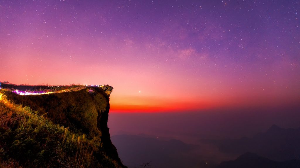 Milky way and mountain range view from the peak of Phu Chi Fa hill, Chiang Rai, Thailand