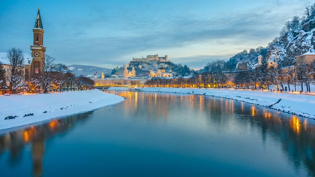 Historic city of Salzburg with Salzach river in winter blue hour, Salzburger Land, Austria
