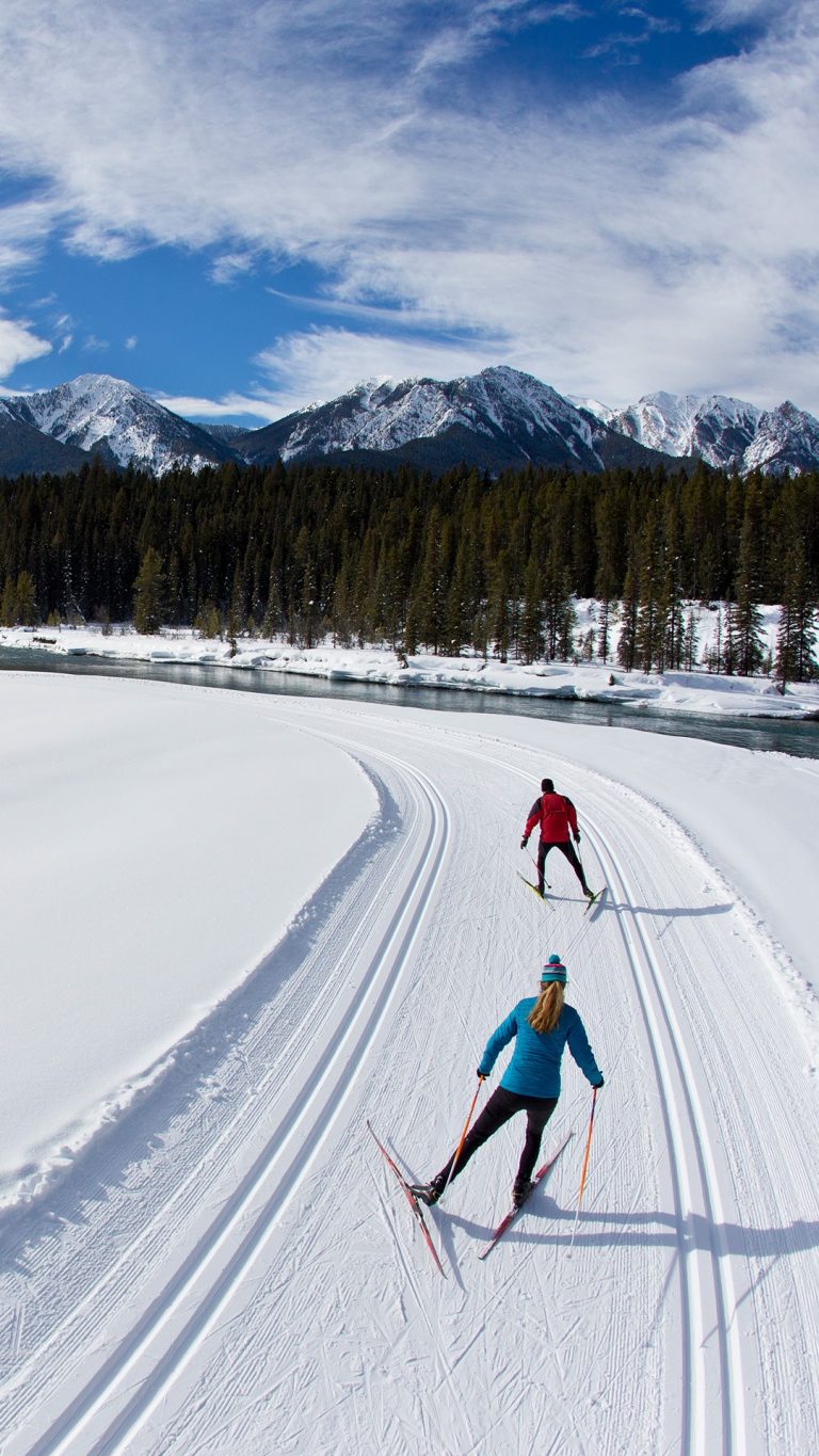 A man and woman enjoy a crosscountry skate ski in the Rocky Mountains