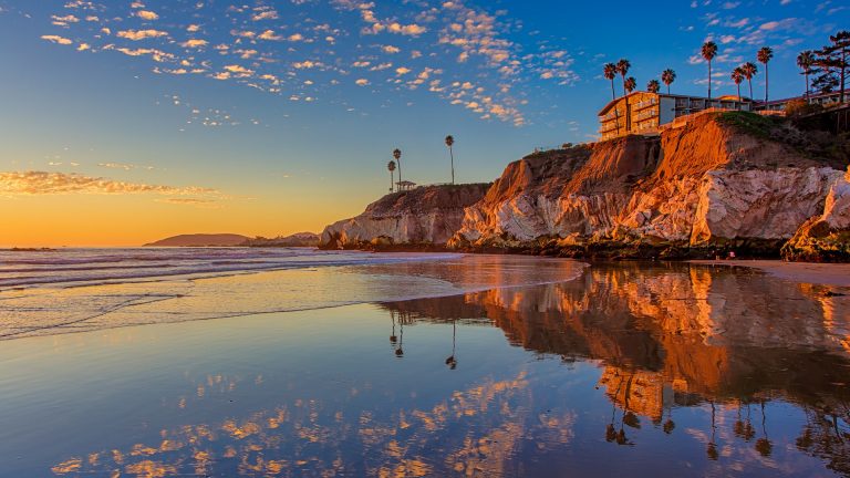 Sunset at the north end of Pismo Beach, cliff at low tide, California ...