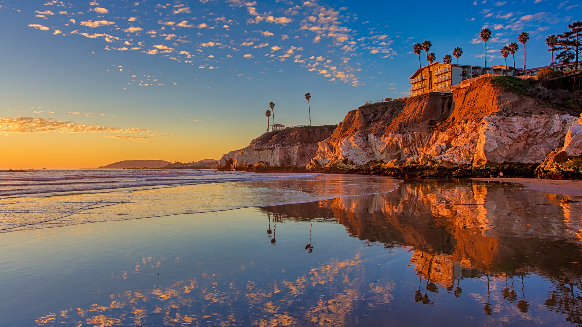 Sunset at the north end of Pismo Beach, cliff at low tide, California