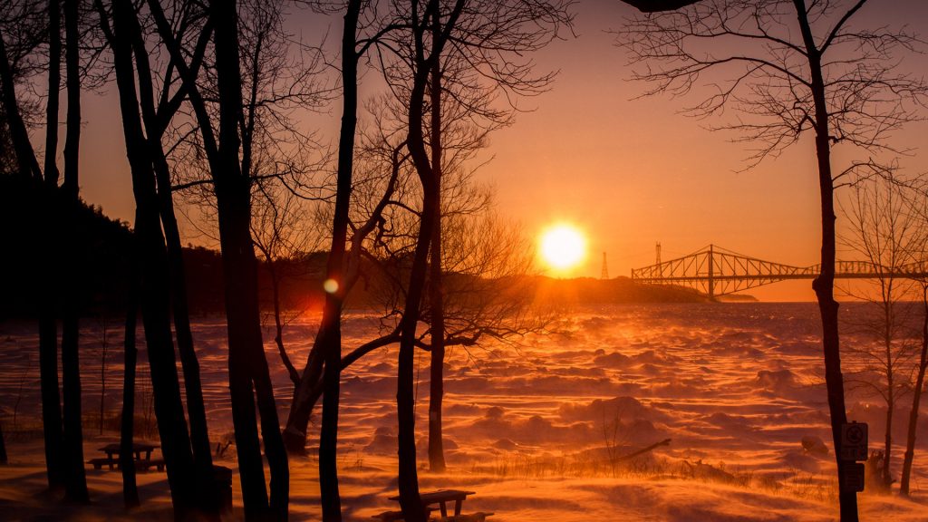 Winterly sunset, warm sky on a glacial day, Saint Lawrence River, Quebec, Canada