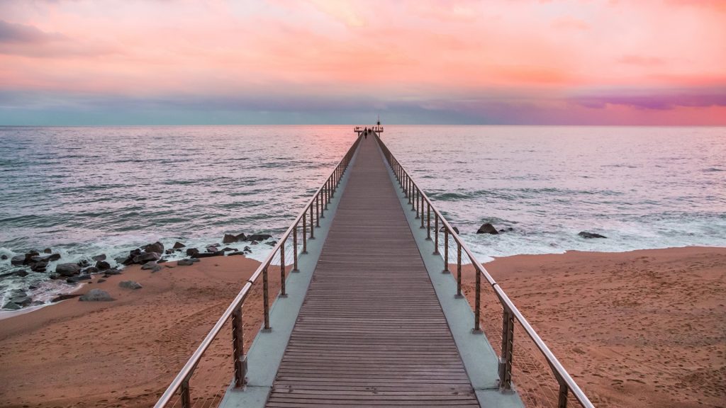 Pedestrian walkway pier at Pont del Petroli beach, Badalona, Catalonia, Spain