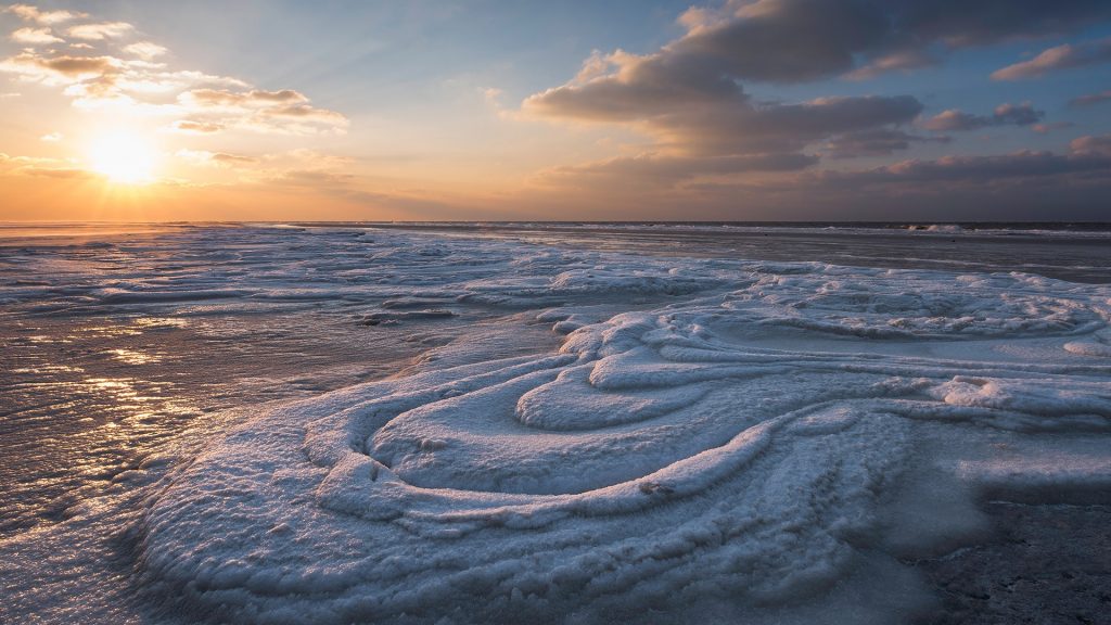 Frozen sea foam on the beach of Schiermonnikoog, Friesland, Netherlands
