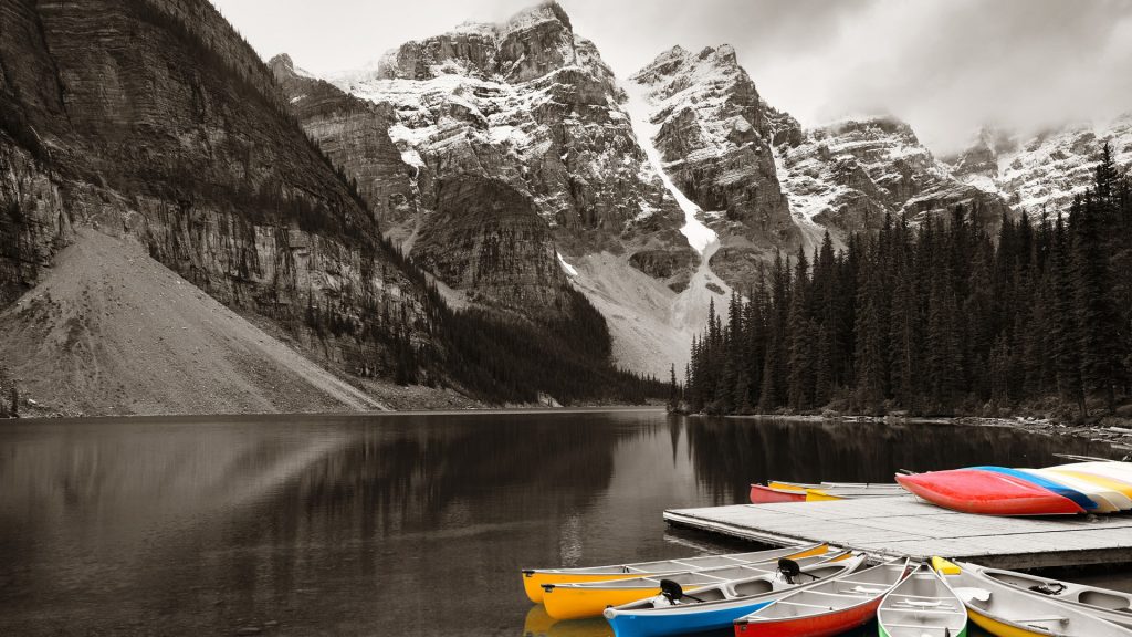 Moraine Lake and boats with snow capped mountain, Banff National Park, Alberta, Canada
