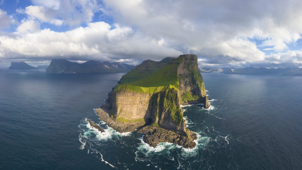 Aerial panorama of Kallur lighthouse and cliffs, Kalsoy island, Faroe Islands, Denmark