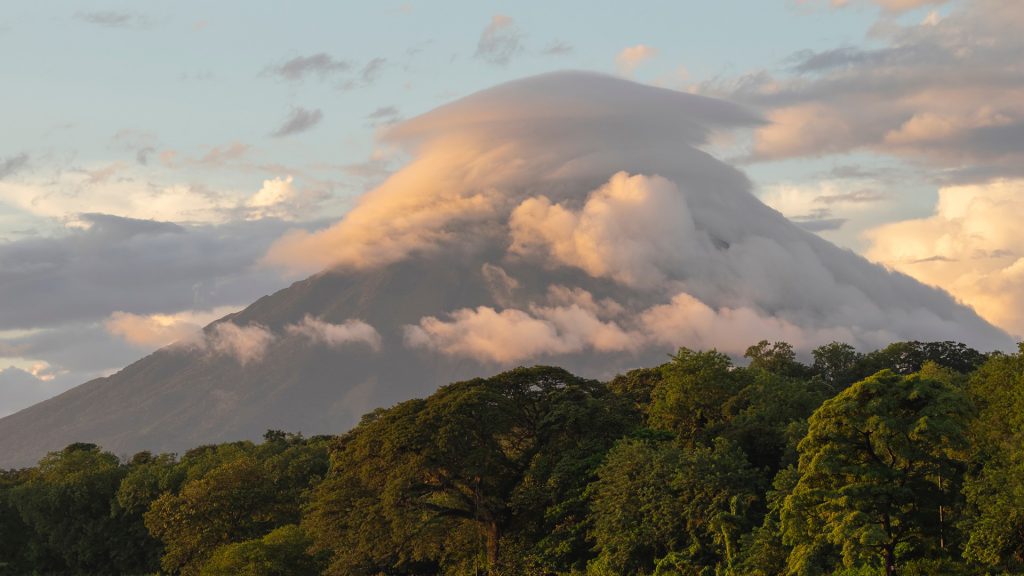 Volcano Concepción on Ometepe island in Lake Nicaragua covered by lenticular cloud at sunset
