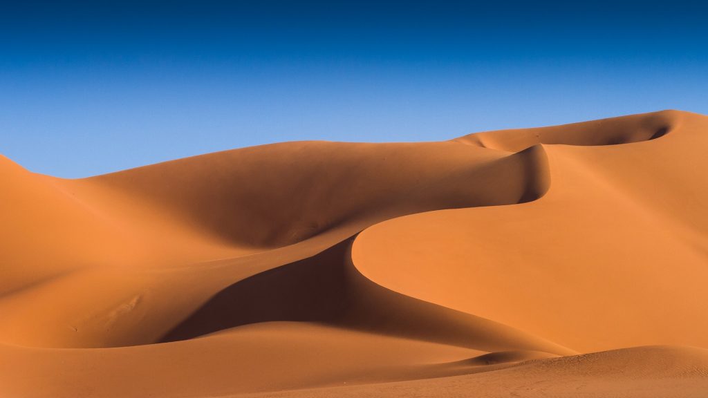 Golden silky Sahara desert sand dunes at sunset, In Amenas, Illizi, Algeria