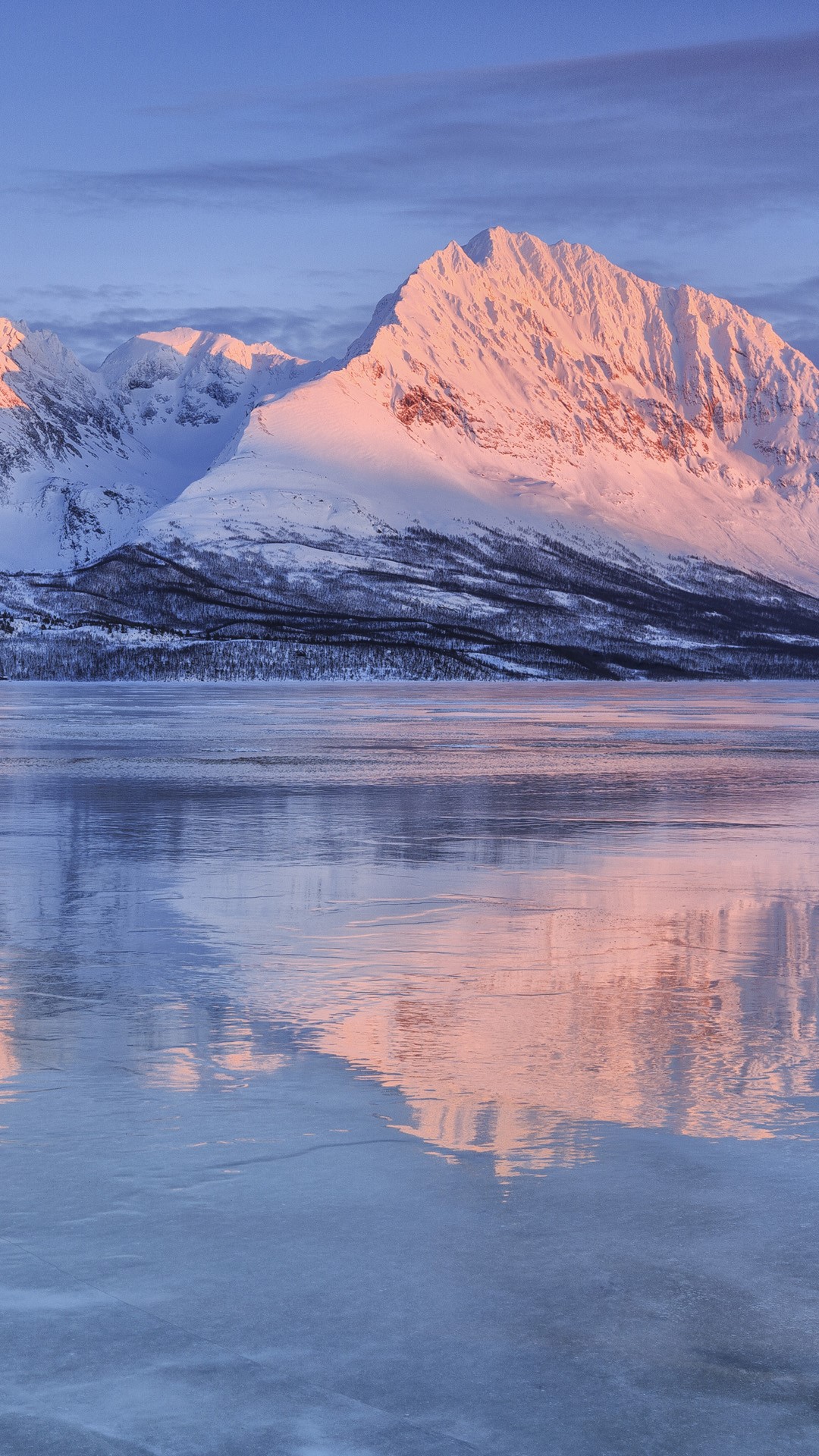 Snowy peaks at frozen Lake Jaegervatnet at sunset, Stortind 