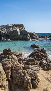 Rocks on the beach on a sunny day, Lloret de Mar, Girona, Spain ...