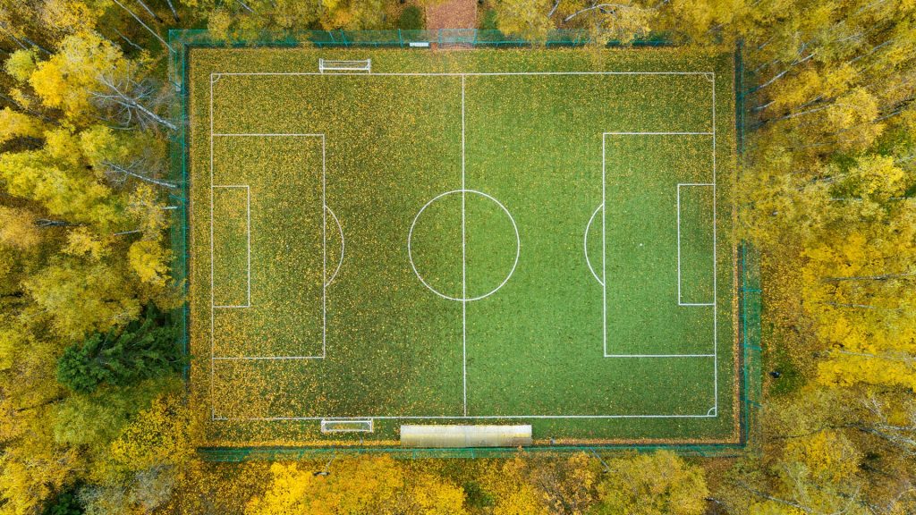 Football pitch surrounded by autumn yellow forest, Russia