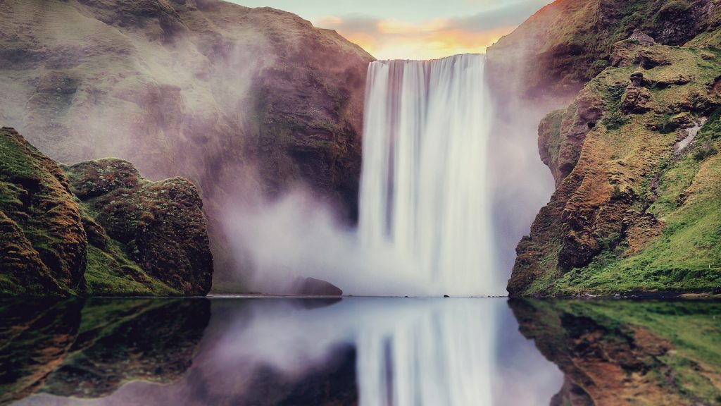 Skogafoss waterfall view with reflections at summer sunset, Iceland