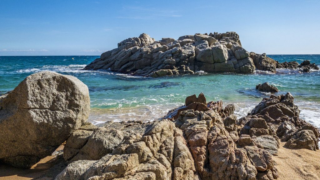Rocks on the beach on a sunny day, Lloret de Mar, Girona, Spain