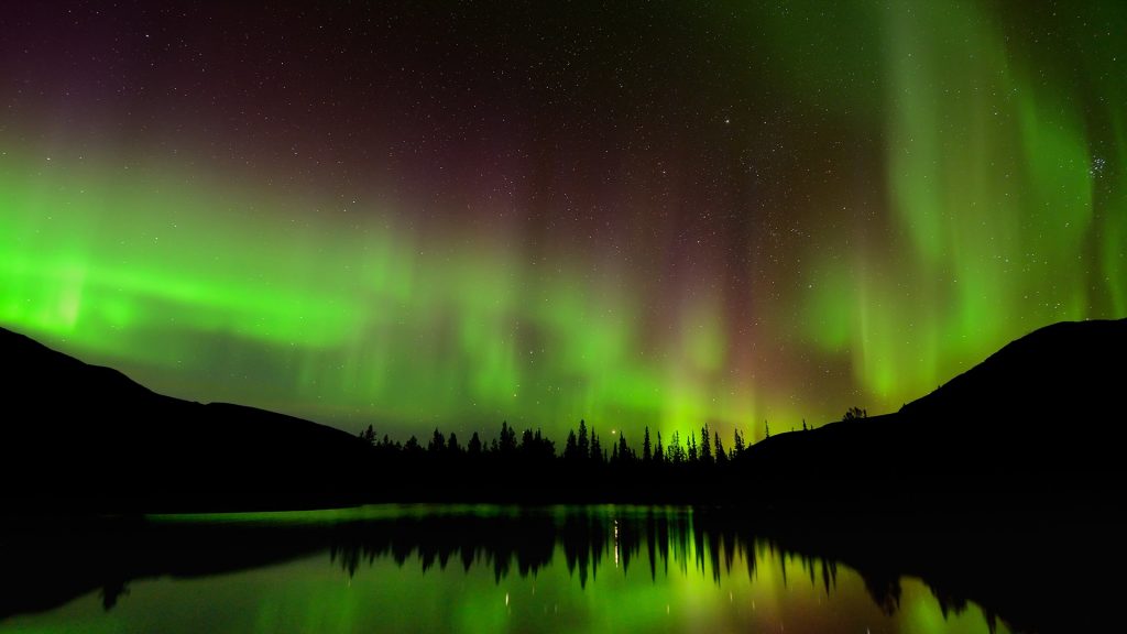 Green aurora borealis at Polygonal Lakes at night, Khibiny mountains, Kola Peninsula, Russia