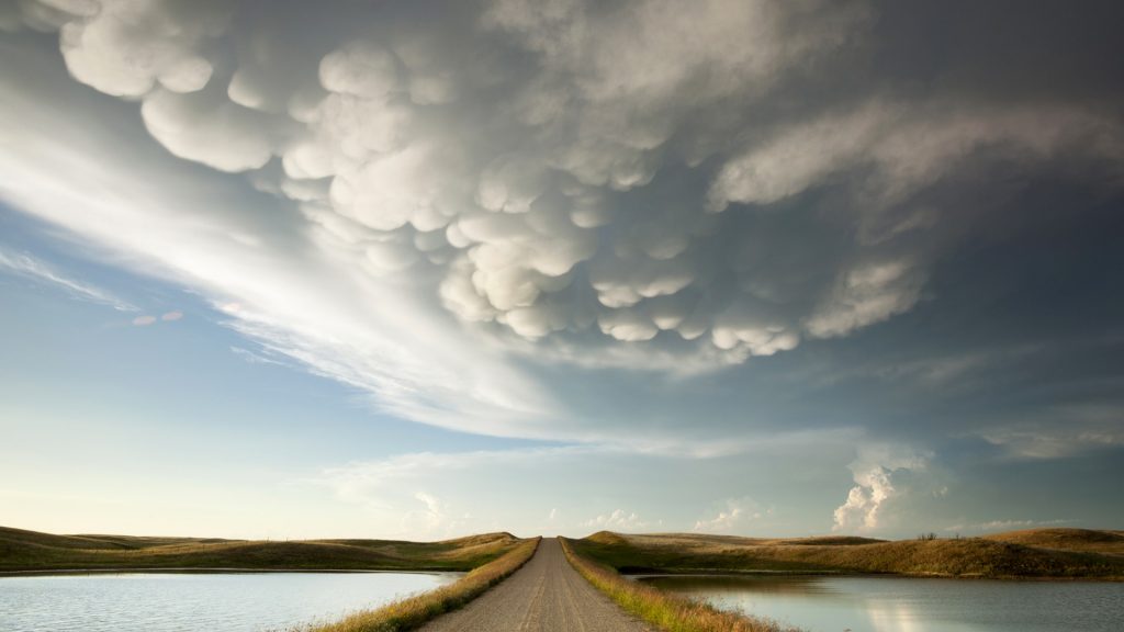 Mammatus storm clouds over a prairie dirt road, Saskatchewan, Canada