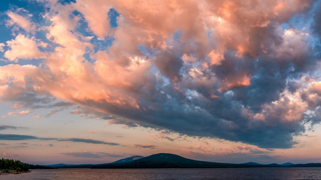 Coming storm in summer, huge dark clouds over lake, Zyuratkul National Park, Russia