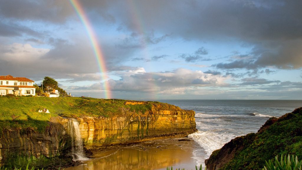 Rainbow over cliff with waterfall in Santa Cruz, California, USA