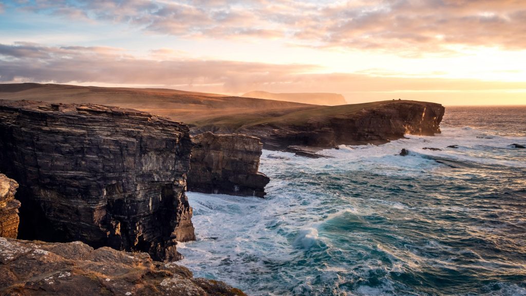 Dramatic waves and cliffs with sunset background, Orkney Islands, Scotland, UK