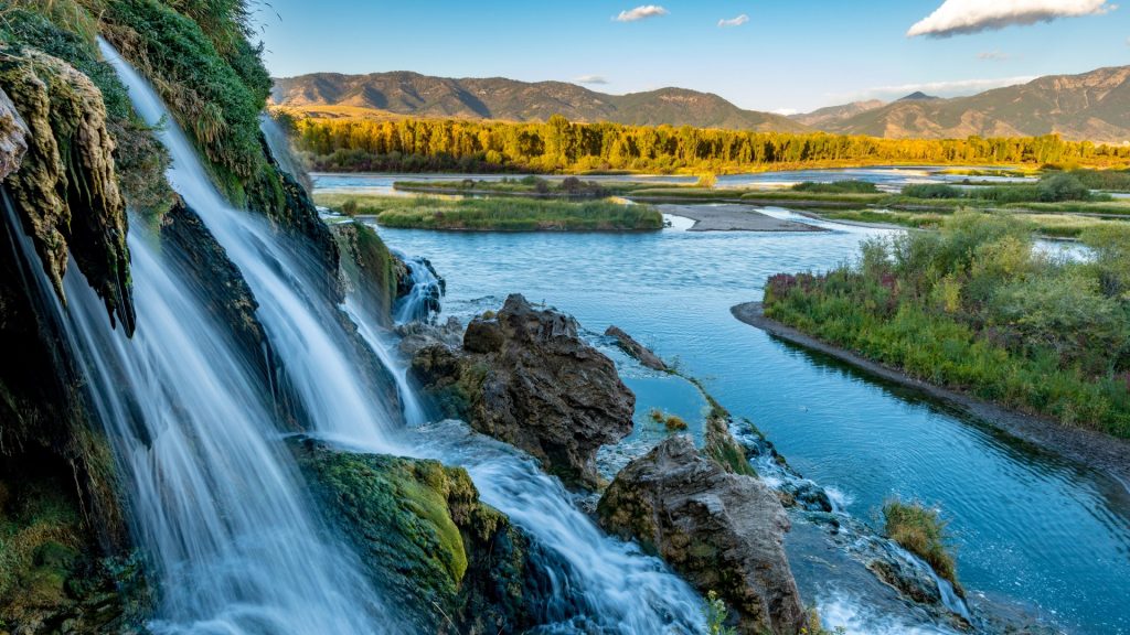 Small waterfall flows into the Snake River, Swan Valley, Idaho, USA