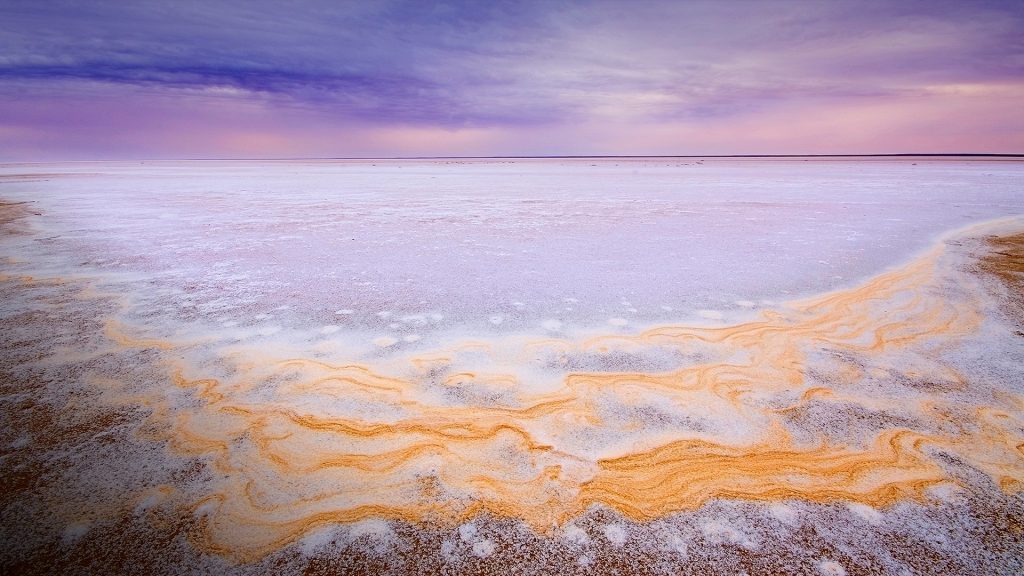 Dry salt pan on pastel sunrise and yellow patterns, Lake Eyre, South Australia
