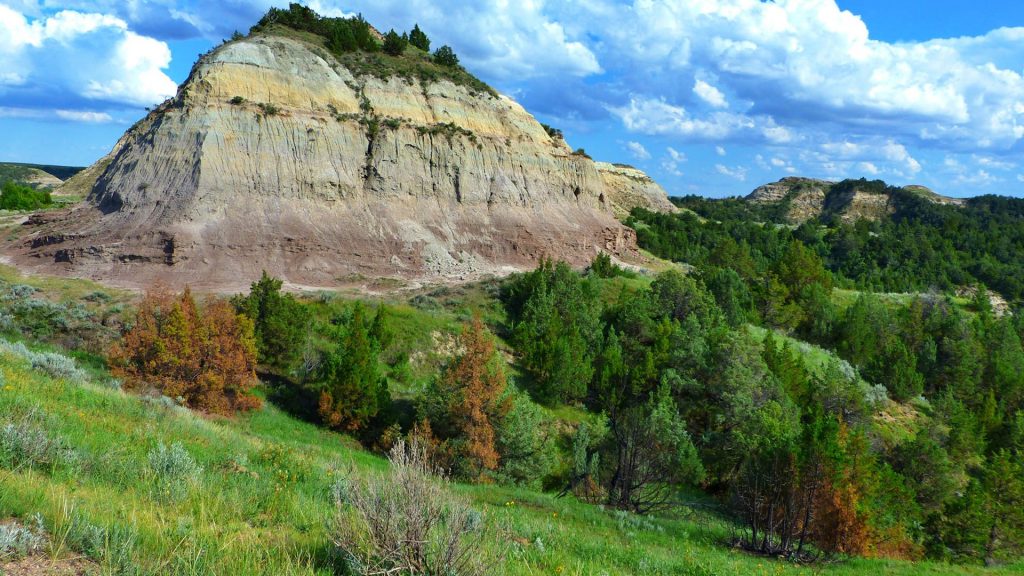 A butte rises from the badland landscape, Theodore Roosevelt National Park, North Dakota, USA
