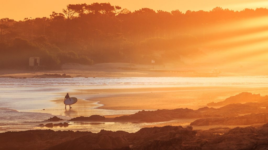 Surfer at "La Barra" beach at sunset, Punta del Este, Maldonado, Uruguay