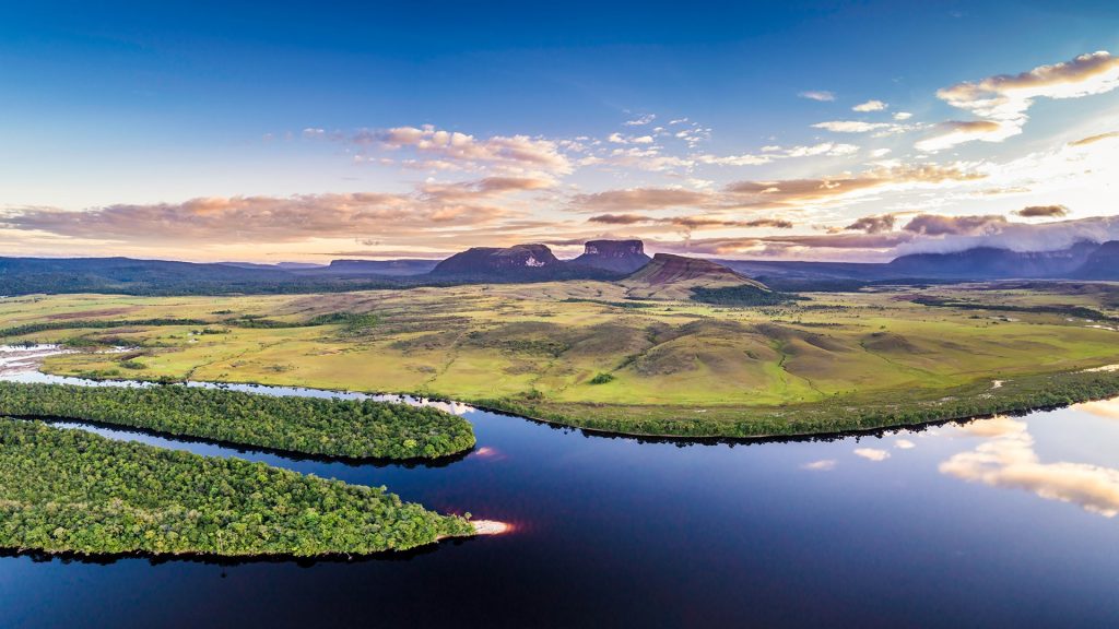 Aerial morning view of Canaima National Park tepuis and the Carrao river at Ucaima, Venezuela