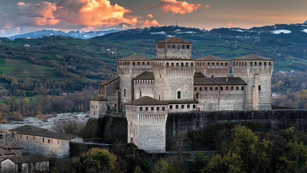 Torrechiara castle at twilight and the Cusna mount, Langhirano, Emilia Romagna, Italy