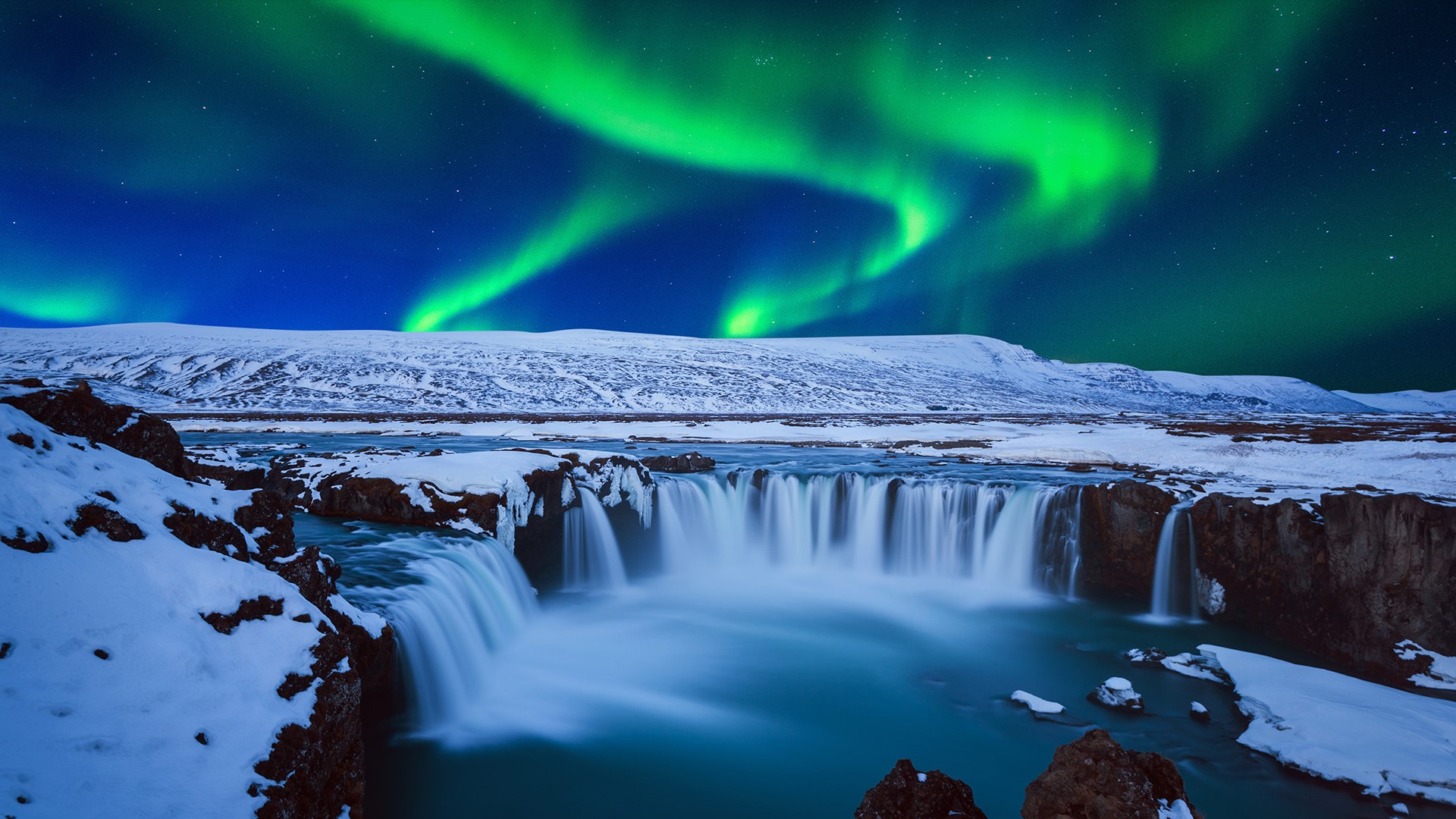 Northern Lights Aurora Borealis At Godafoss Waterfall In Winter 