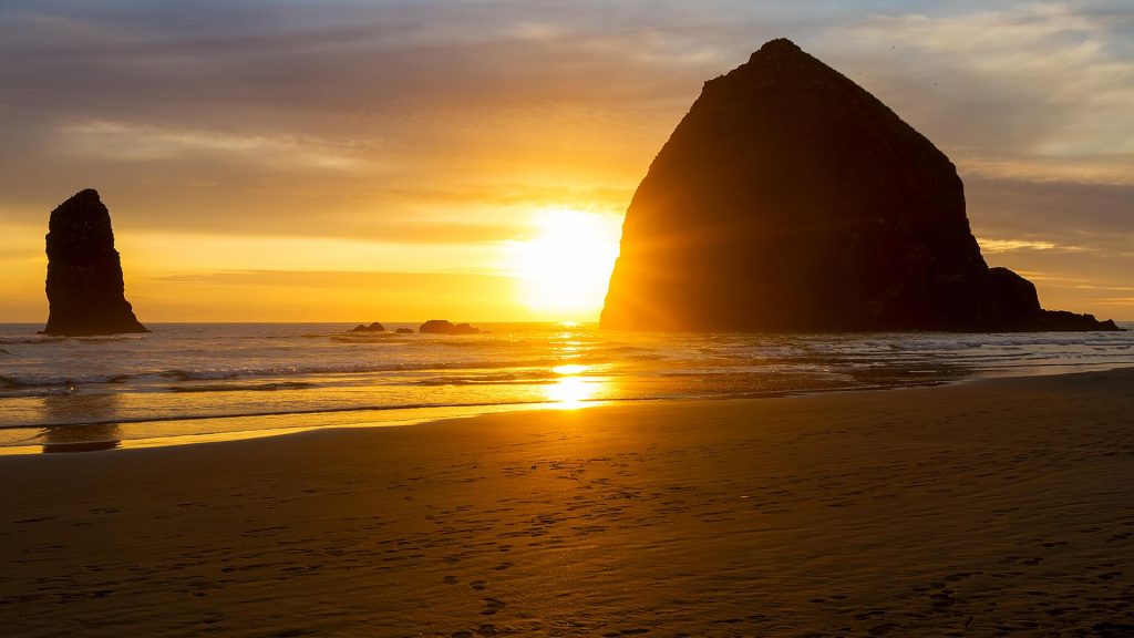 Sunset by Haystack Rock at Cannon Beach on Oregon coast, USA