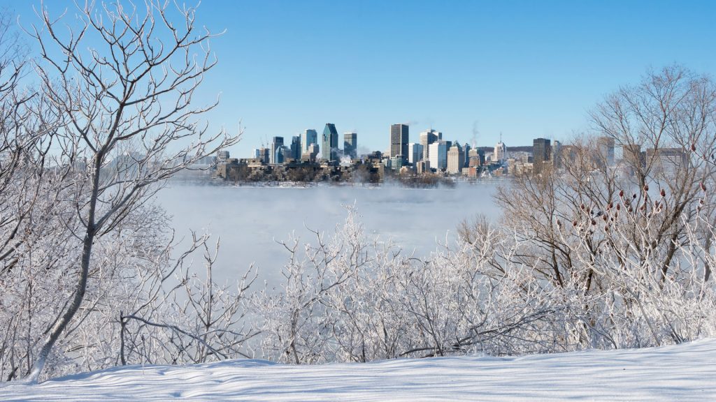 Montreal Skyline in winter as ice fog rises off the St. Lawrence River, Quebec, Canada