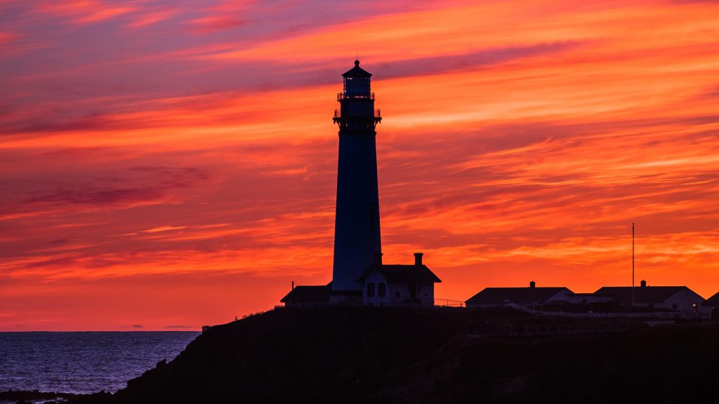 Fiery sunset at Pigeon Point Lighthouse on the Pacific Ocean coast, Pescadero, California, USA