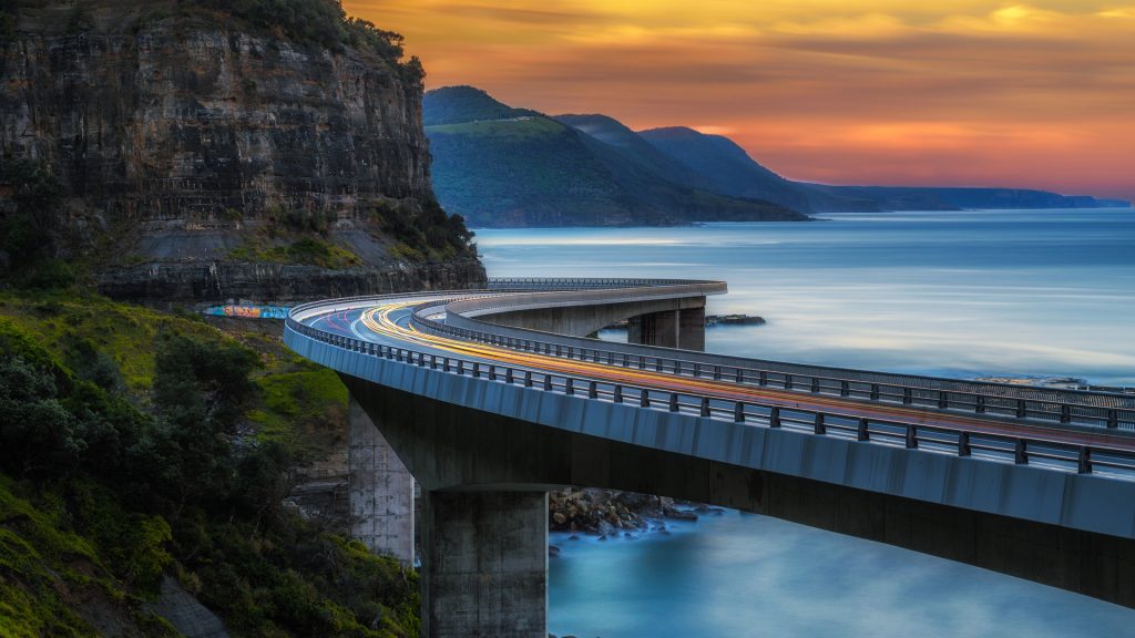 Sunset over the sea cliff bridge along Australian Pacific ocean coast near Sydney, Australia