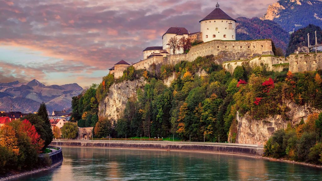 Kufstein Old Town with medieval fortress on a rock over the Inn river at sunset, Austria