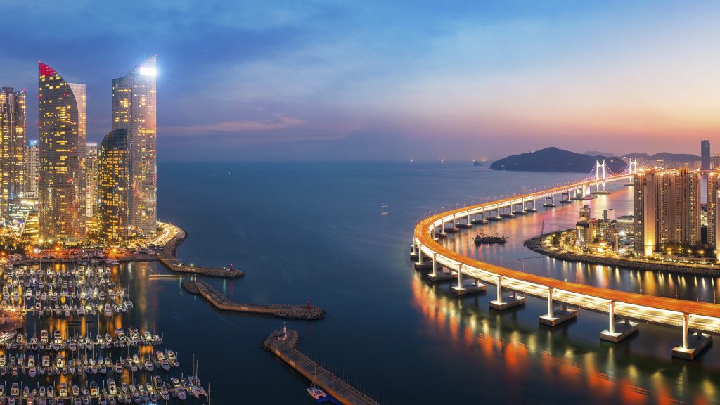 Sunset in Busan city with buildings, bridge and harbor, South Korea