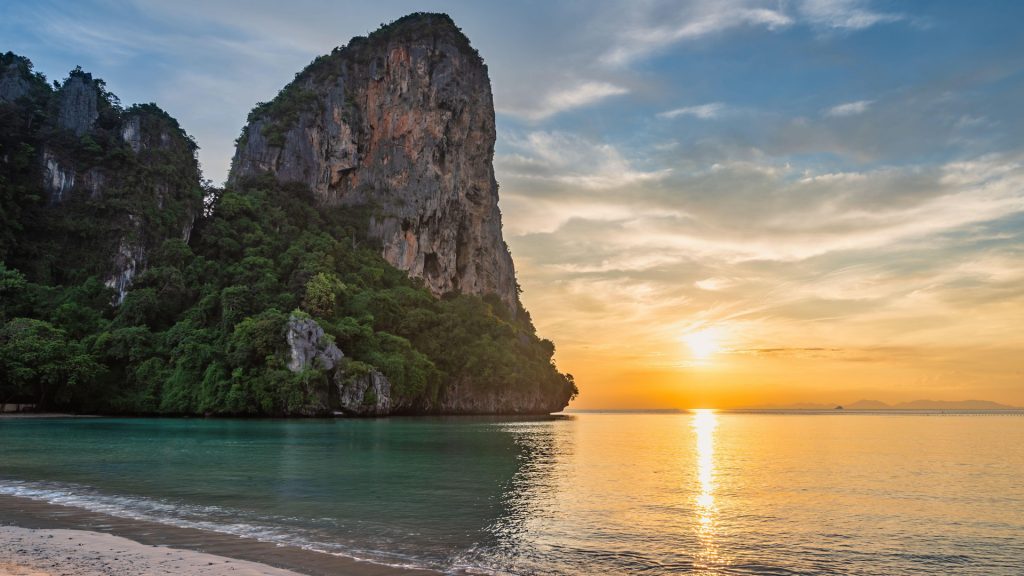 Tropical islands sunset view with ocean and white sand at Railay Beach, Krabi, Thailand