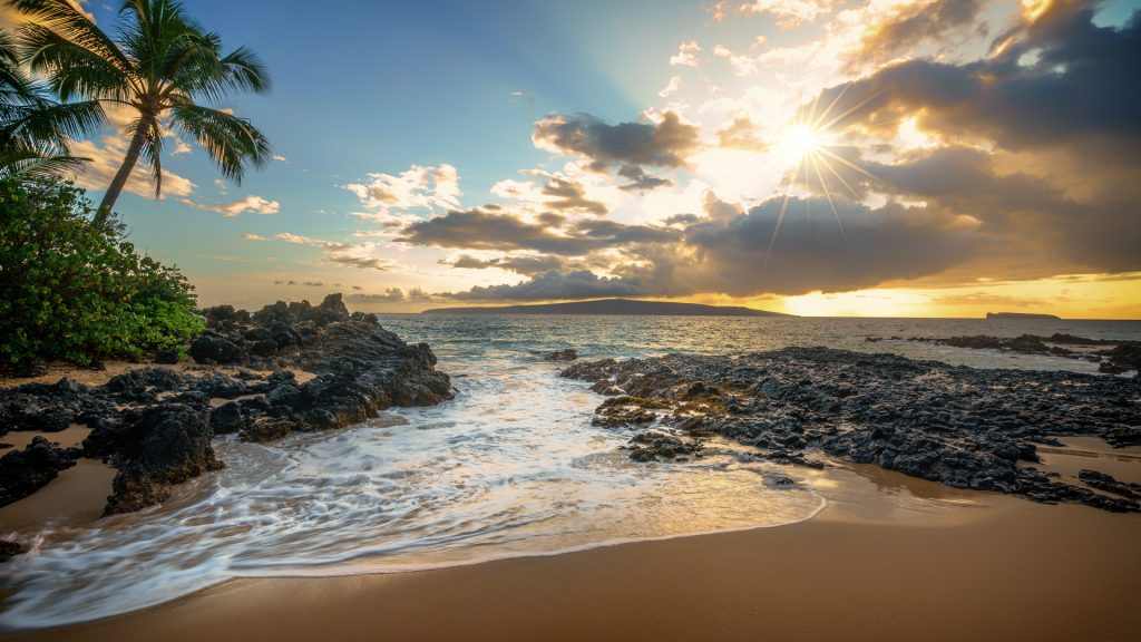 A sunset reflecting in the coastal tidal pools of Makena Cove beach, Maui, Hawaii, USA
