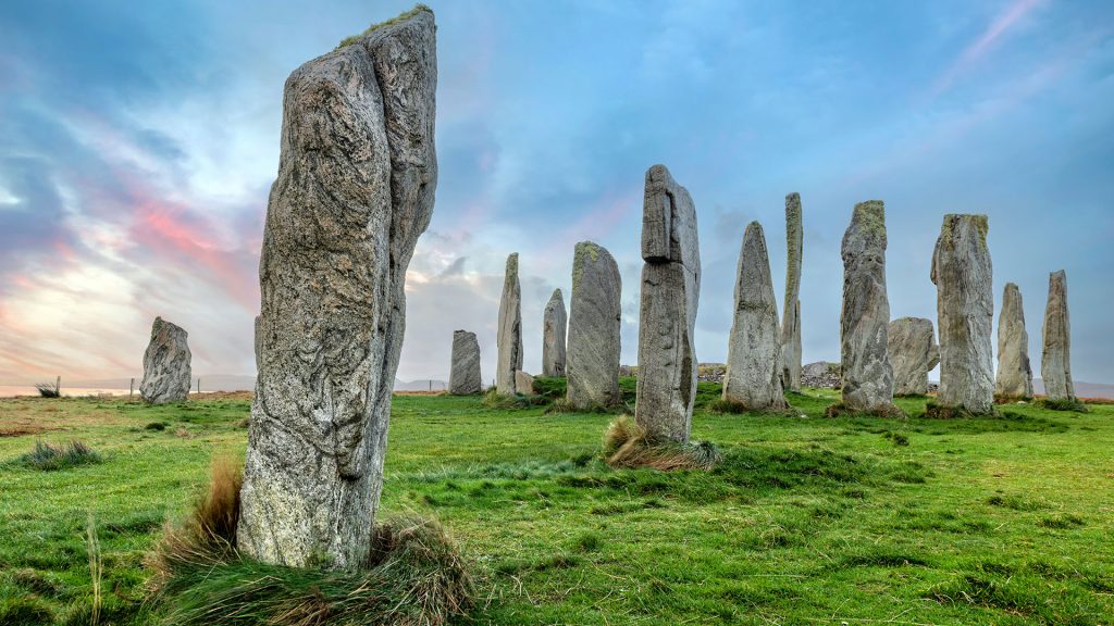 Calanais standing stones on the Isle of Lewis in Scotland on a cloudy day with a blue sky, UK